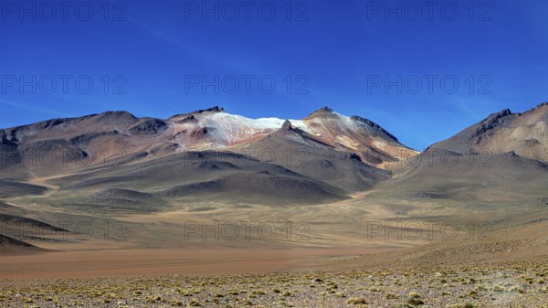 Rocky mountains under a deep blue sky in an arid region, The landscape with the volcanoes on the Altiplano in Bolivia