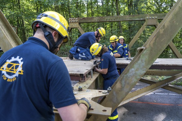 Construction of a temporary bridge over a slipped road crossing a stream, by the bridge construction section of the THW, 18 metre long steel bridge of the Krupp-D type, is assembled in around 8 hours, large-scale exercise FÜLEX25 lasting several days, of the THW North Rhine-Westphalia regional association, over 3500 volunteers from the 127 North Rhine-Westphalia local associations practise on 4 weekends, many different deployment scenarios