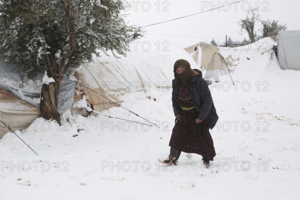Displaced Syrian families and children living in refugee camps during harsh winter conditions, facing snow, cold weather, and difficult humanitarian circumstances. Aleppo, Syria January 01, 2022, Aleppo, Syria
