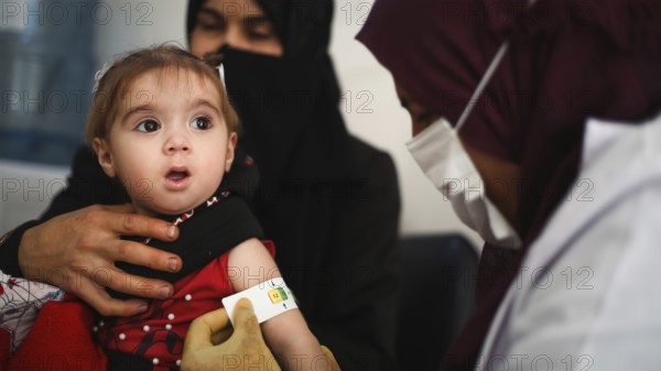 A doctor examines children's malnutrition inside a refugee camp. Malnutrition was measured using a mid-upper arm circumference belt. Aleppo, Syria October 29, 2022, Aleppo, Syria