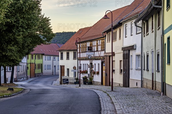 Idyllic old town with half-timbered houses and cobbled street in a quiet evening mood, the village of Mühlburg in Thuringia near Erfurt