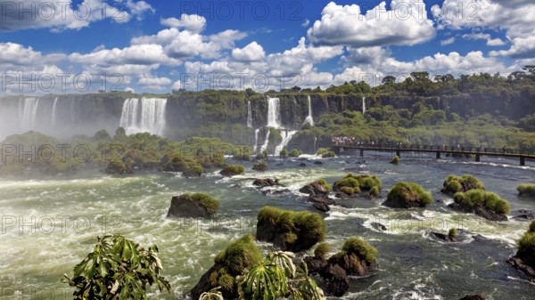 Impressive waterfall landscape with river and bridge on a cloudy day, The Iguazu Falls between Argentina and Brazil