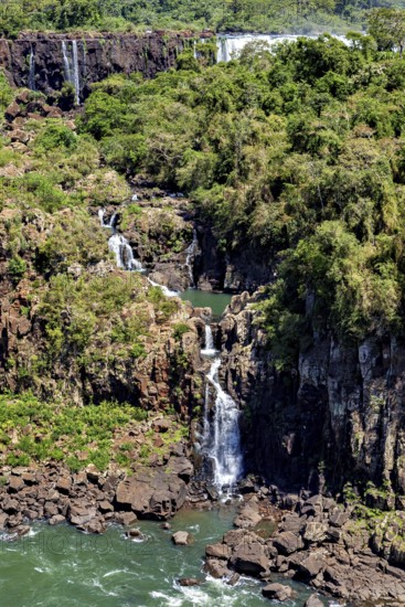 High waterfall with surrounding forest and rocks, harmonious natural scenery, The Iguazu Falls between Argentina and Brazil