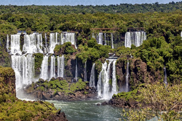 Extensive water landscape with numerous cascades, framed by dense forest, The Iguazu Falls between Argentina and Brazil