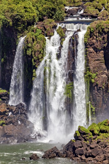 Close-up of impressive waterfalls cascading over moss-covered rocks, The Iguazu Falls between Argentina and Brazil
