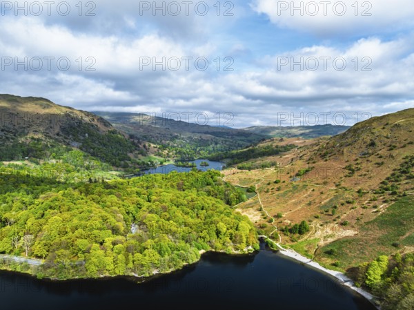 Farms and Mountains over road A591 from a drone, Grasmere Lake, Grasmere, Ambleside, Lake District, Westmorland, Cumbria, UK