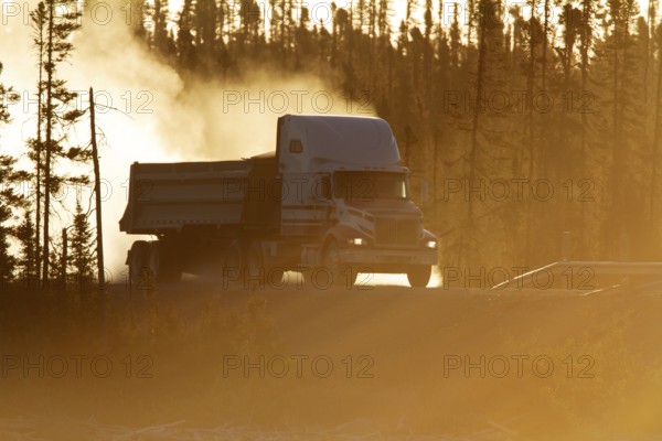 Transport truck driving on a dusty forest track, Province of Quebec, Canada, North America