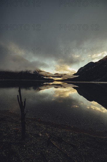 Sunrise with reflections in the Plansee in Tyrol in the Alps in Austria
