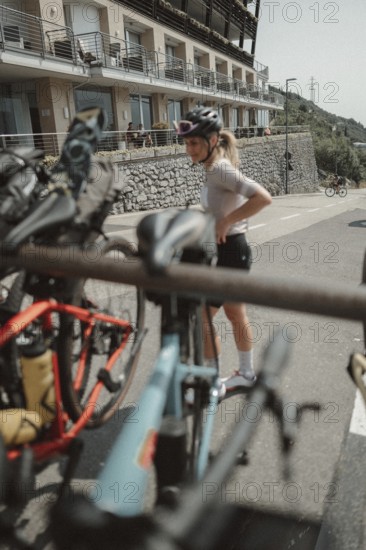 Young woman riding a racing bike on Lake Garda. Sunny weather and dolce vita