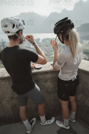 Young man taking a coffee break while riding his racing bike on Lake Garda. Sunny weather and dolce vita
