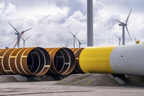 The seaport of Eemshaven, Julianahaven Basin, where the foundation structures, monopiles, for offshore wind farms are stored, which then support the actual wind turbines, the components are transported to the wind farms in the North Sea on large workboats and anchored to the seabed, where the wind turbines are then built, Eemshaven, Netherlands