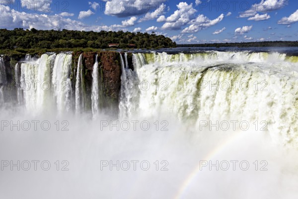 Impressive waterfalls with spraying spray under a cloudy sky, The Iguazu Falls between Argentina and Brazil