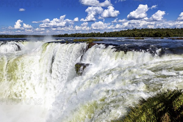 Close-up of a rushing waterfall showing a strong water current, The Iguazu Falls between Argentina and Brazil