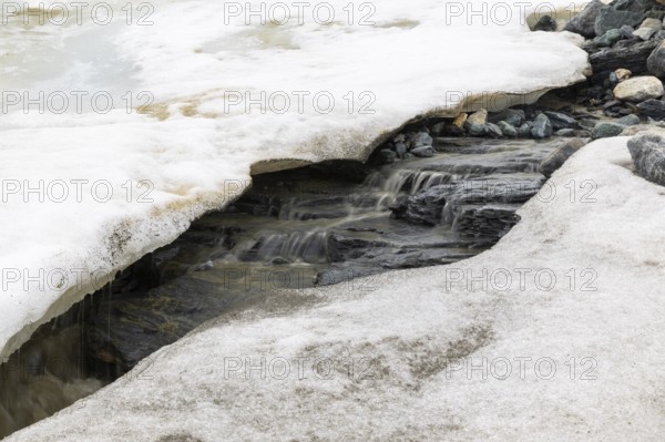 Melting glacier, stones, water, Cooper Camp, Spitsbergen, Svalbard