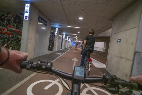Ride your bike into and out of the bicycle car park at Utrecht Centraal station, Stationsplein, over 13, 000 parking spaces, considered the largest bicycle car park in the world, over 3 underground floors, Utrecht, Netherlands