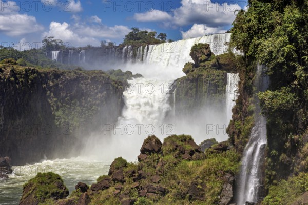 Mighty waterfalls cascade over rocky cliffs in nature, The Iguazu Falls between Argentina and Brazil