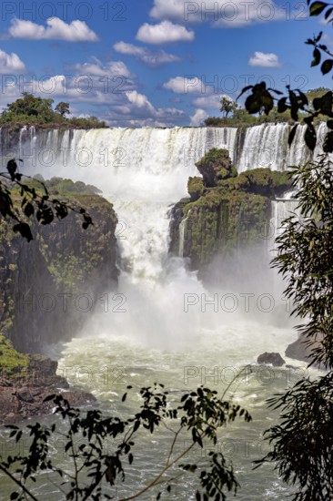 Close-up of a thundering waterfall with lush greenery, The Iguazu Falls between Argentina and Brazil
