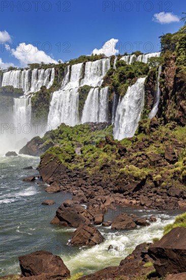 Close-up of waterfalls cascading over rocks in dense green growth, The Iguazu Falls between Argentina and Brazil