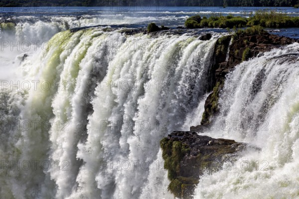 Mighty waterfall with cascading masses of water and swirling spray, The Iguazu Falls between Argentina and Brazil