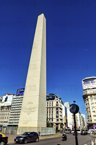 A tall obelisk under a clear blue sky surrounded by modern buildings, The Great Obelisk in the city of Buenos Aires Argentina