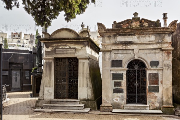 Two adjoining tombs in a cemetery with decorative elements, La Recoleta Cemetery in Buenos Aires Argentina