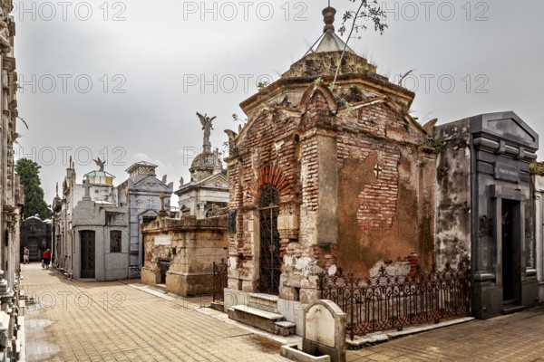 Old mausoleums in a cemetery with angel figures and weathered architecture, La Recoleta Cemetery in Buenos Aires Argentina
