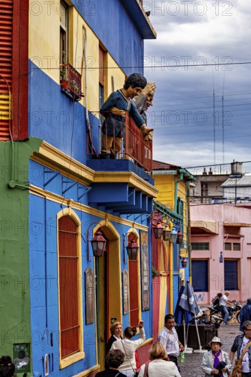 Lively street with balcony sculptures and colourful houses in La Boca, the colourful city and tango district of La Bocca in Buenos Aires Argentina