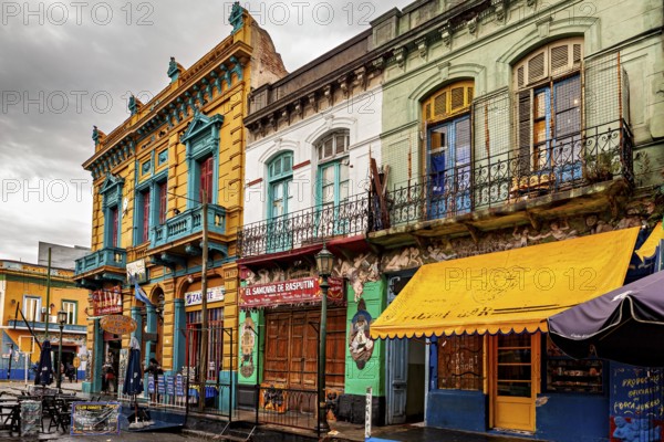 Traditional colourful facades along a cloudy street backdrop, The colourful city and tango district La Bocca in Buenos Aires Argentina