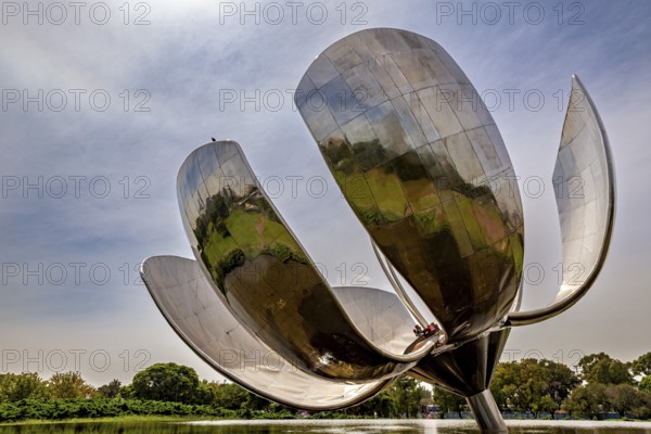 Close-up of a large metal flower sculpture with clouds in the sky, The lotus blossom in Buenos Aires Argentina