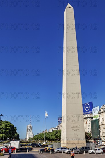 A tall obelisk under a clear sky in Buenos Aires in daylight, flanked by cars, The great obelisk in the city of Buenos Aires Argentina