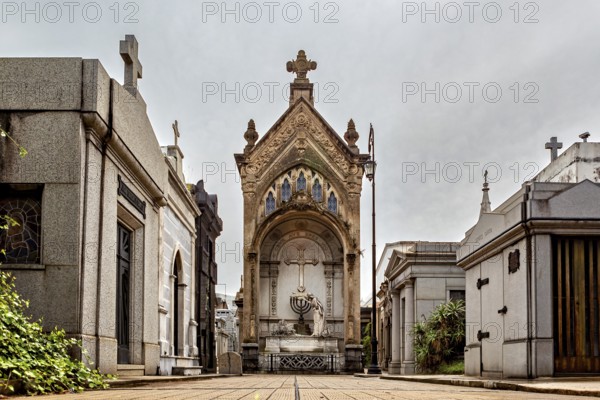 Large mausoleum with cross in a well-kept cemetery, La Recoleta cemetery in Buenos Aires Argentina