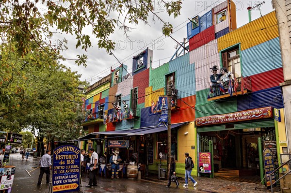 A colourful façade full of artists and shops attracts people despite the rain clouds, The colourful city and tango district of La Bocca in Buenos Aires Argentina