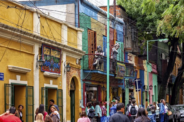 Lively street view with sculptures and colourful buildings in La Boca, the colourful city and tango district of La Bocca in Buenos Aires Argentina