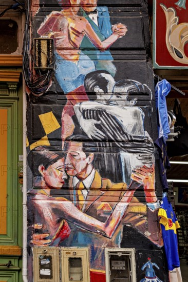 Artistic mural of dancing couples in vibrant colours on a city wall, The colourful city and tango district La Bocca in Buenos Aires Argentina
