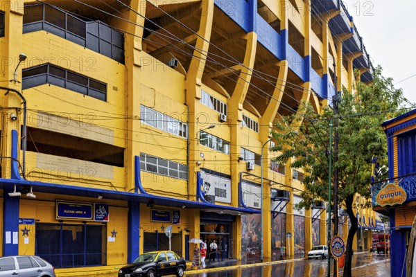 Yellow and blue stadium on a rainy street with trees, The football stadium of La Bocca of Bocca Juniors in Buenos Aires Argentina