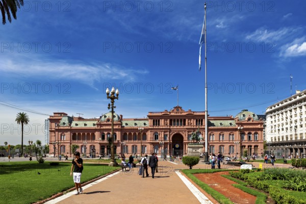 Historic building with surrounding gardens and flag, sunny day in Buenos Aires, The presidential palace Casa Rosada in Buenos Aires Argentina