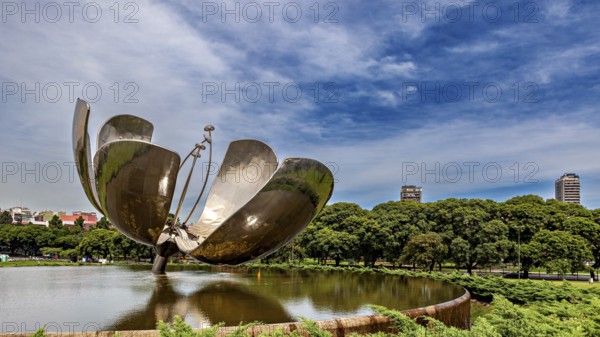 Architectural metal flower in a park with urban backdrop and blue sky, The lotus flower in Buenos Aires Argentina