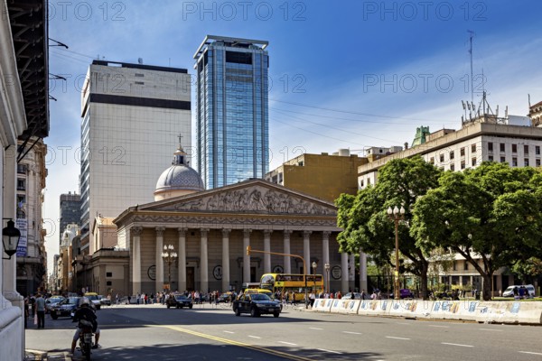 A grand cathedral and modern buildings along a busy tree-lined street, The city of Buenos Aires in Argentina