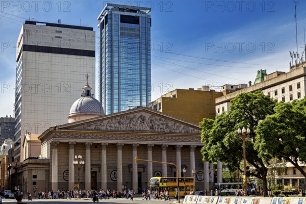 An impressive cathedral with modern skyscrapers in the background, surrounded by trees, The city of Buenos Aires in Argentina