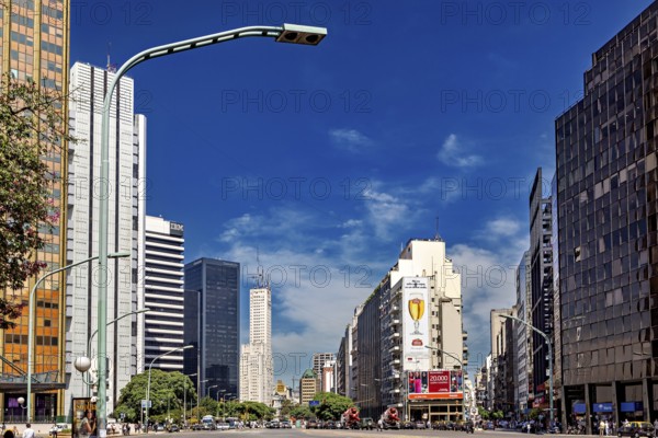 A busy city street with modern skyscrapers and heavy traffic under a blue sky, The city of Buenos Aires in Argentina