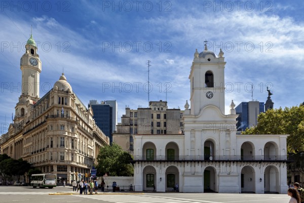 Historic white buildings with a clock tower, busy street and blue sky with few clouds, The city of Buenos Aires in Argentina