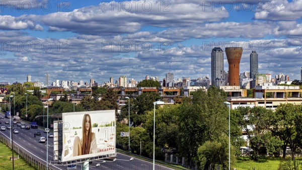Cityscape with skyscrapers, a large billboard and busy traffic under a cloudy sky, The city of Buenos Aires in Argentina