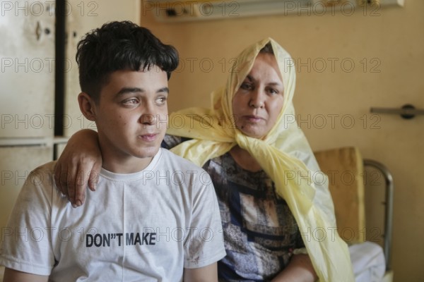 Wounded individuals receiving treatment at a hospital after being evacuated with difficulty from Sweida city in southern Syria due to sectarian violence between Druze factions and Bedouin tribes