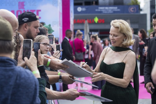 Pamela Anderson signs autographs in front of the film premiere of The Naked Gun at UCI Luxe East Side Gallery, Berlin, 24.07.2025