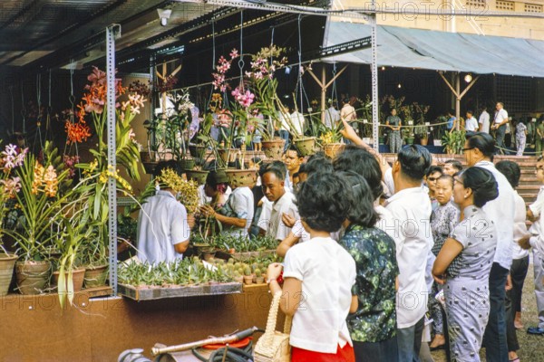 People attending flower show at the Singapore Turf Club, The 4th World Orchid Conference, Singapore, Southeast Asia, October 3-10, 1963