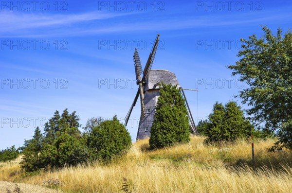 Historic windmill in an epic summer landscape near the burial ground of Stenhusbacken and the village of Sunnersberg near Lidköping, Västergötland, Västra Götalands län, Sweden