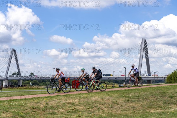 Cycle path in the Neulandpark in Leverkusen on the Rhine, in the background the new Rhine bridge of the A1, 1 construction phase, near Leverkusen, participants of the North Rhine-Westphalia Cycle Tour, 4-day, 220 KM long round trip through the Rhineland, with over 1400 participants, North Rhine-Westphalia, Germany