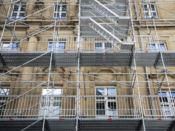 Scaffolded façade of the district court with metal platforms and stairs in Wuppertal, Germany
