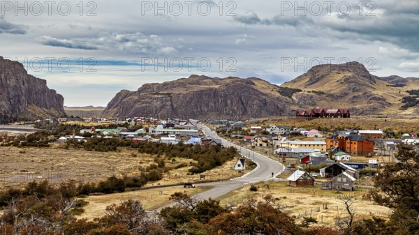 A small village nestled in a hilly landscape along a winding road, the village of El Chalten in Patagonia, Argentina