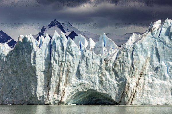 Dramatic glacier with threatening clouds and mountains in the background, The Perito Moreno glacier in Argentina